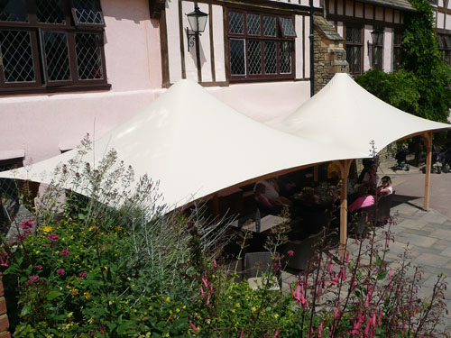  A tensile fabric square coned gazebo with a timber frame 