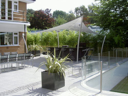  A tensile fabric hypar canopy with four curved tubular steel posts