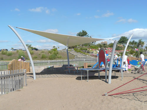  A tensile fabric hypar canopy with four curved tubular steel posts