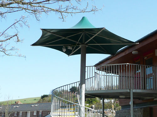 A tensile fabric hexagonal coned umbrella with a tubular steel column