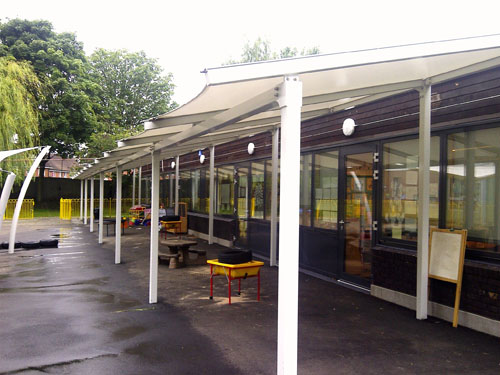  A tensile fabric freestanding single pitch canopy with tubular steel frame